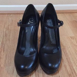 Black leather Cole Haan platform heels.